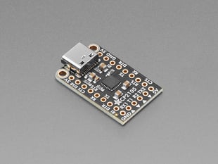 Angled shot of black, rectangular USB-to-serial breakout board.