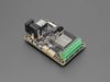 Angled shot of rectangular LED driver PCB with green terminal blocks.