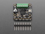 square-shaped motor driver breakout with green terminal blocks above a piece of 10-pin header.