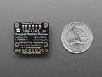 Back of square-shaped stepper motor driver breakout next to US quarter for scale.