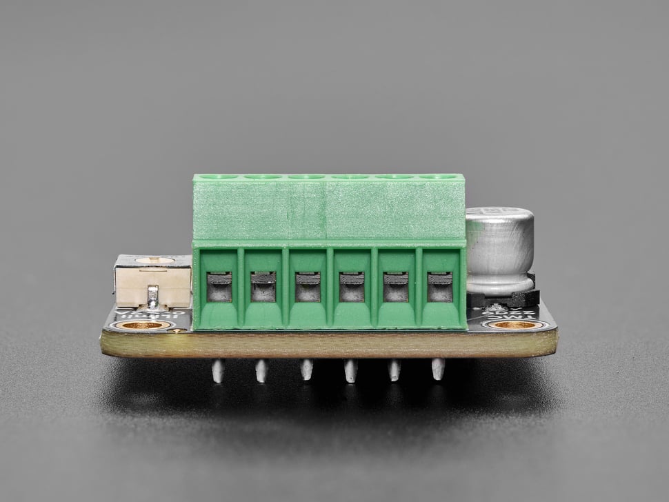 Close-up of green terminal blocks on PCB.