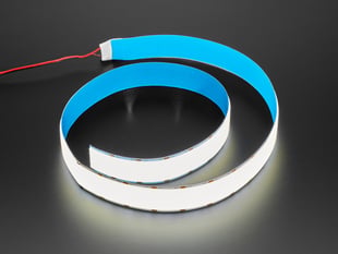 Semi-coiled one-meter long LED strip emitting cool white light.