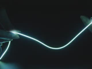 Video of Black hand articulating 300mm long green LED filament.