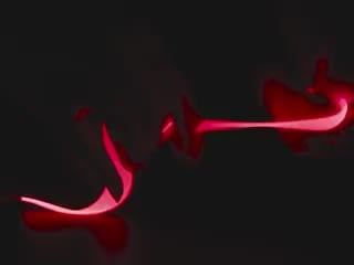 Video of Black hand articulating red LED filament.
