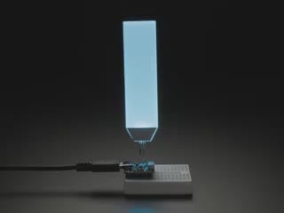 Video of medium-sized, rectangular backlight display plugged into a small breadboard with microcontroller. Backlight display cycles through colors.