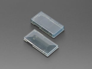Angled shot of two translucent-black rectangular enclosure pieces.