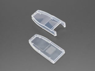 Angled shot of Two clear plastic enclosure pieces for a USB dongle.