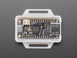 Overhead shot of black, rectangular microcontroller in milky white enclosure-half.