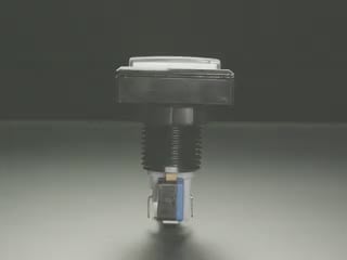 A white hand pressing an index finger on a push-button.