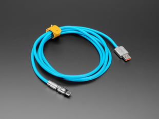 Angled shot of blue, coiled, USB-A-to-USB-C swivel head cable.