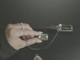 Demo Video of a hand turning a magnet behind the sensor board and getting a reading to appear on the display screen connected to the board.