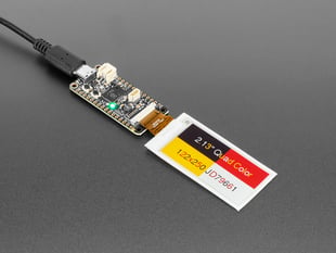 Demo Shot of the 2.13" 250x122 Quad-Color eInk / ePaper - Bare Display connected to an Ink Feature and text "2.13" Quad Color 122x250 JD79661" Displayed on the Screen with the Text and Rectangular shapes in the background in four different colors. 