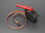 Red servo arm installed on a servo motor.