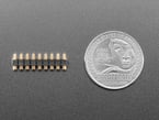 9-pin pogo pin header with U.S. quarter for scale.