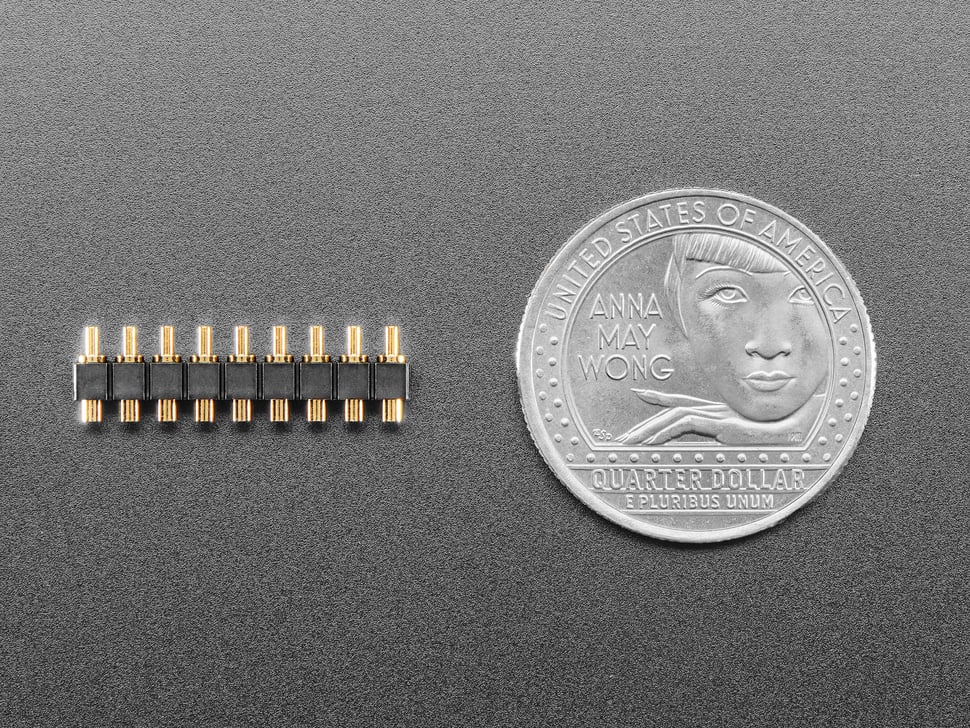 9-pin pogo pin header with U.S. quarter for scale.