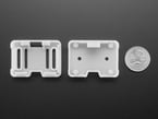 two white 3D-printed enclosure pieces with U.S. quarter for scale.