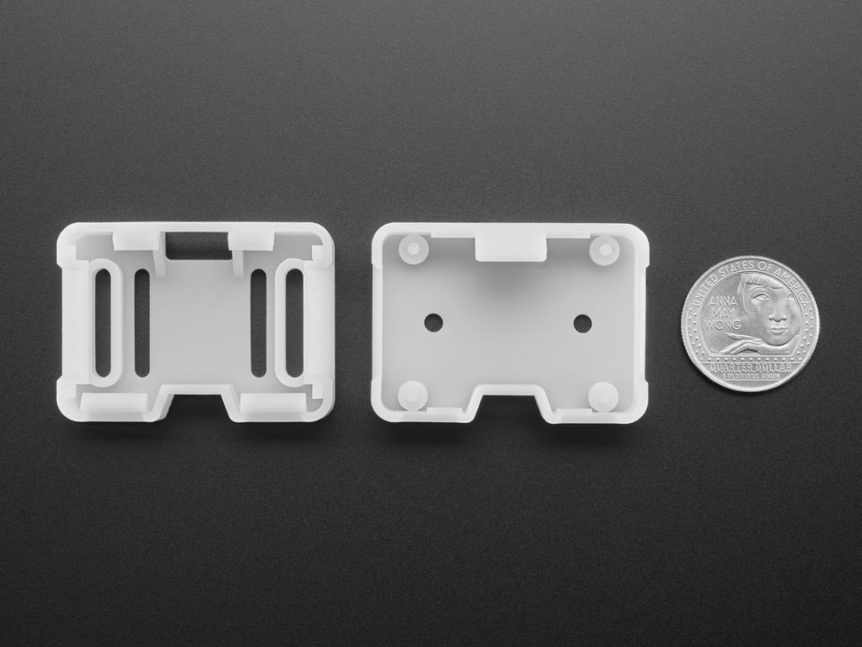 two white 3D-printed enclosure pieces with U.S. quarter for scale.