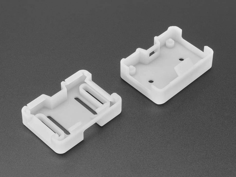 Angled shot of two white 3D-printed enclosure pieces.