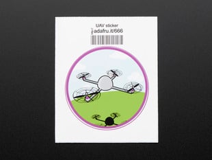 Circular sticker showing a small grey drone over a stylized blue sky, with white clouds, and green grass. Badge is trimmed in purple. Mounted on white paper with barcode.  