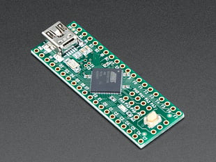 Angled shot of Teensy++ dev board with AT90USB128 chip and mini USB port.